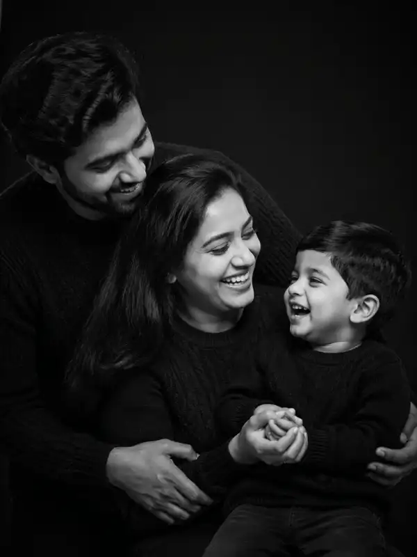 chatgpt family photo prompt candid family laughter.webp ChatGPT family photo prompt creating a candid black-and-white portrait of an Indian family laughing together