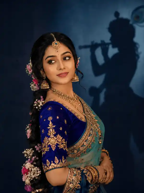 radha rani prompt for gemini ai divine side pose.webp Radha Rani style Indian girl in blue teal lehenga saree with Krishna silhouette shadow